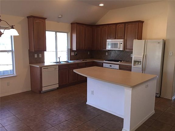 Wonderful, eat-in Kitchen has lots of natural lighting, as well as recessed lights, high ceilings, built-in microwave, an island - with electrical outlets, tile floor, plenty of counter & cabinets space plus a pantry