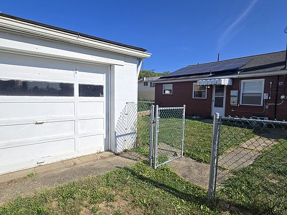 large rear parking area (4-bay garage with room for up to 4 parked cars) leading to fenced back yard