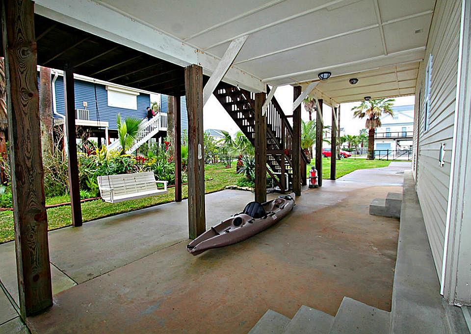 The ground space under this home has many uses, extra parking, storage, outdoor living area.. Your choice! This area also features elevated garage with a bonus area. Kayak and Club Car golf cart convey with purchase!