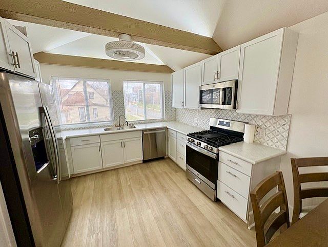 Beautifully remodeled kitchen with uplighting and fans. Lots of countertop space and pantry!