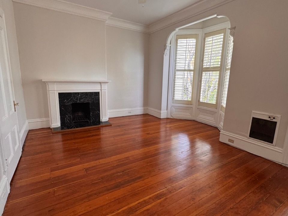 This is a huge bedroom with fireplace and plenty of charm