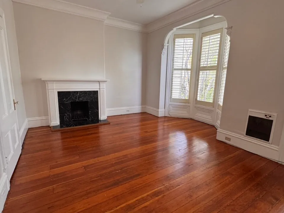 This is a huge bedroom with fireplace and plenty of charm