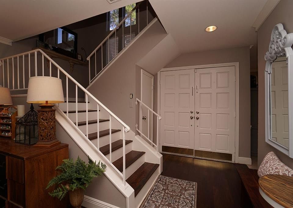 Darling entry with double front doors, rod iron staircase and laminate wood floors!