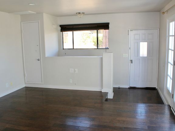 Living room view with front entrance and coat closet