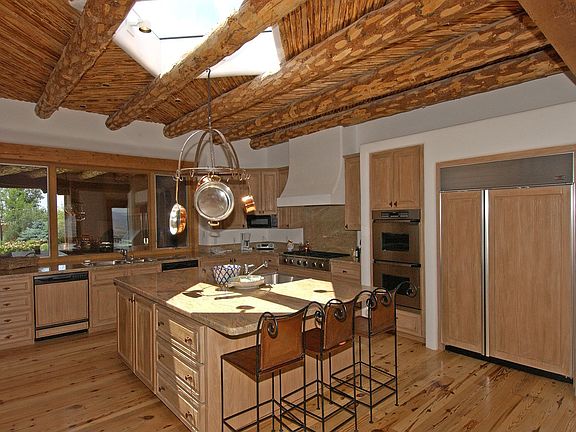 The kitchen is open to the family rm & has views out 2 sides. There is a 6 burner Dacor stove top, a