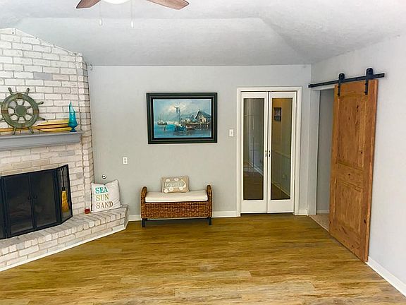 Family room from with gas fireplace. Glass doors lead to front entry hall