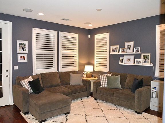 Family room adjacent to kitchen exits to patio and landscaped yard