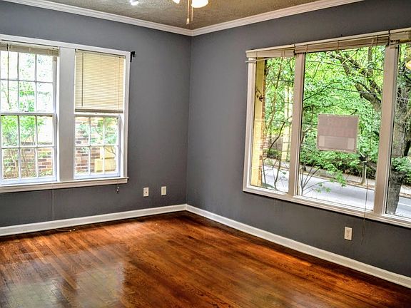 Top floor studio condo overlooking Piedmont Park. 6 foot picture window with view of Piedmont Park. It is a large room - this is the living room side.