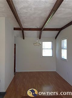 Living/dining room combination with beam ceilings