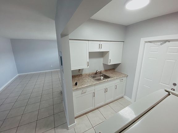 Kitchen w/ second entrance (right) , living room (left)