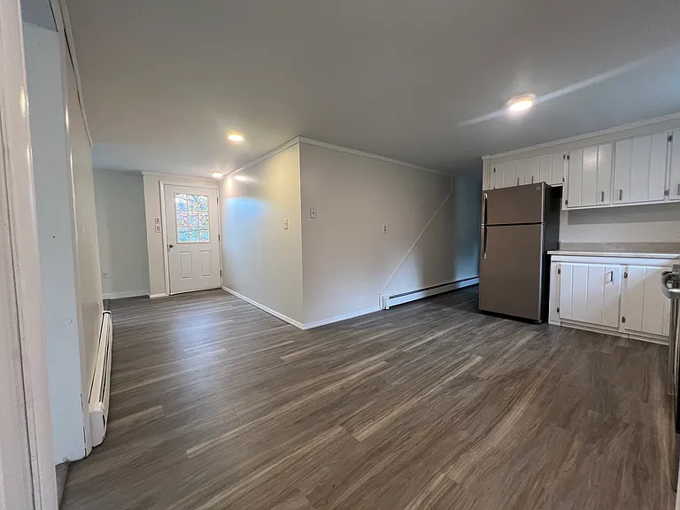 View of kitchen area, plenty of space for your table and access area to front deck.