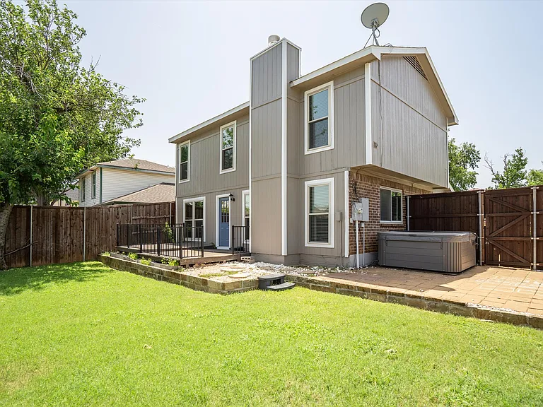The backyard features a deck and side patio with a hot tub for your use.