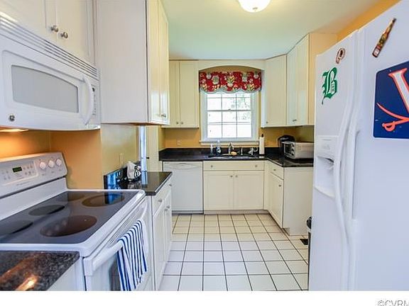 Updated kitchen with granite counters and tile floor.