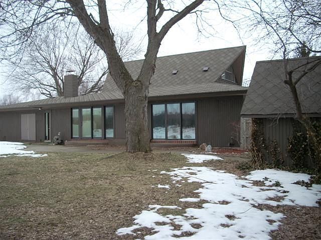 Back of home with shed and 2 sets of large sliders