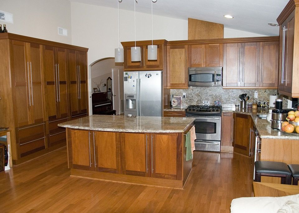 The open kitchen and family room are elegantly upgraded with beautiful granite countertops and high-end, sleek cabinetry that offers abundant storage space.