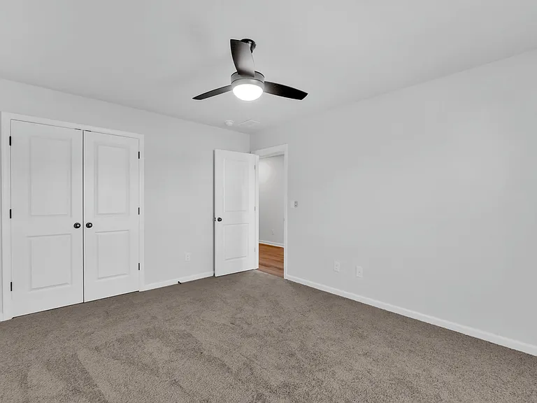Secondary bedroom with closet