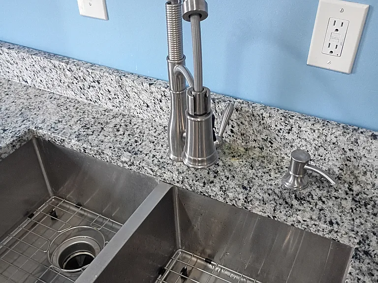 Dual kitchen sink with multi function faucet.