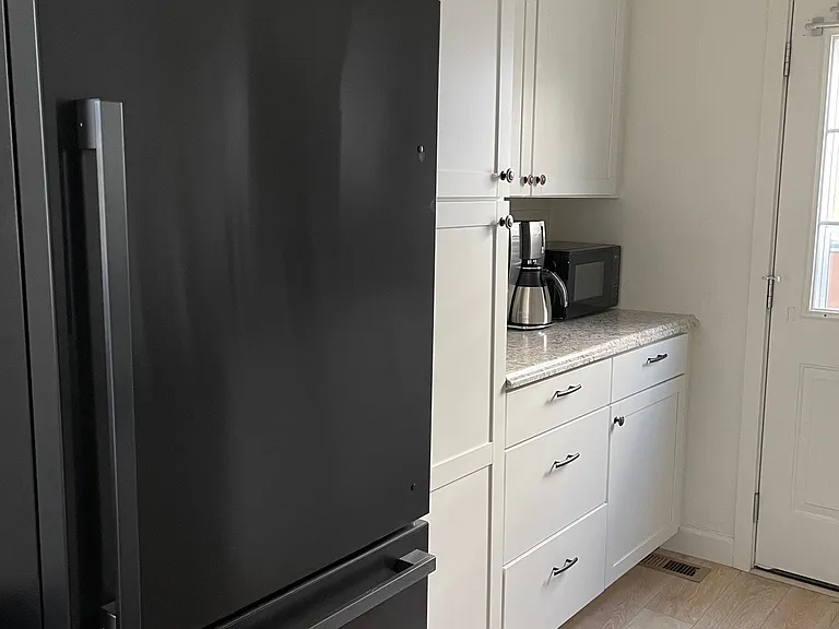current kitchen, black refrigerator included with rental