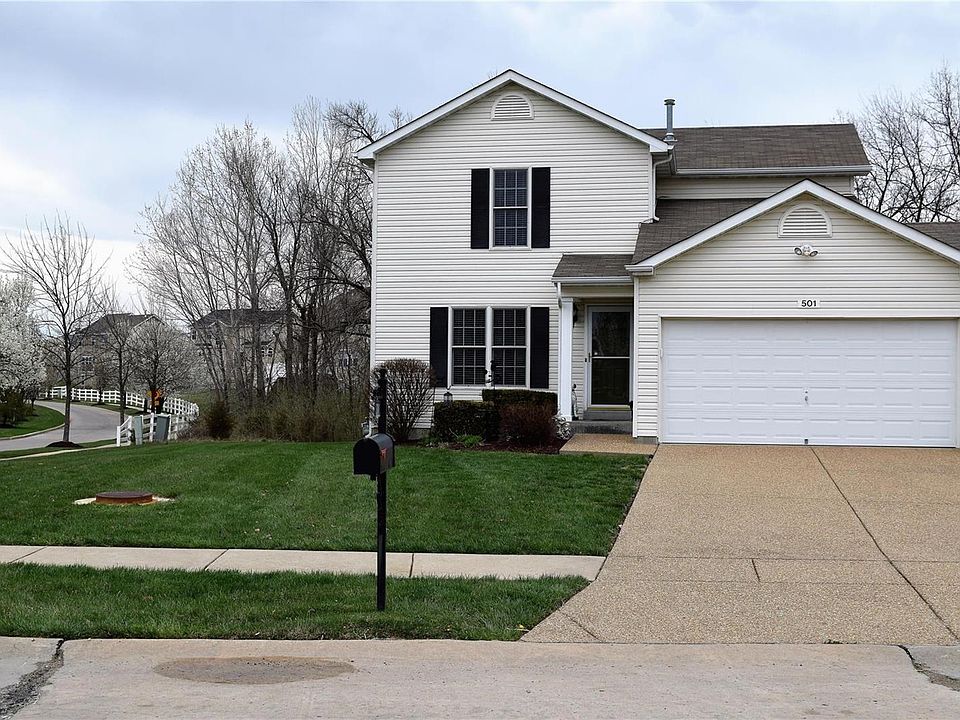 Front elevation of home, convenient corner lot, backs to trees and common ground, in ground sprinkler system front, back, and sides, professionally landscaped, aggregate drive way, two car garage, storm door at front