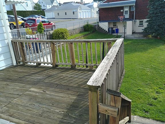 Large deck off kitchen overlooks the backyard, steps lead down to the yard.