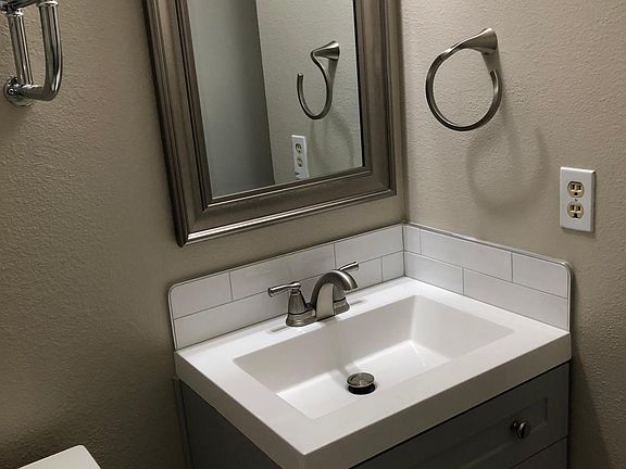 Remodeled 1/2 Bathroom with New Lavatory with Tile Back Splash and Tiled Floors (July 2022)