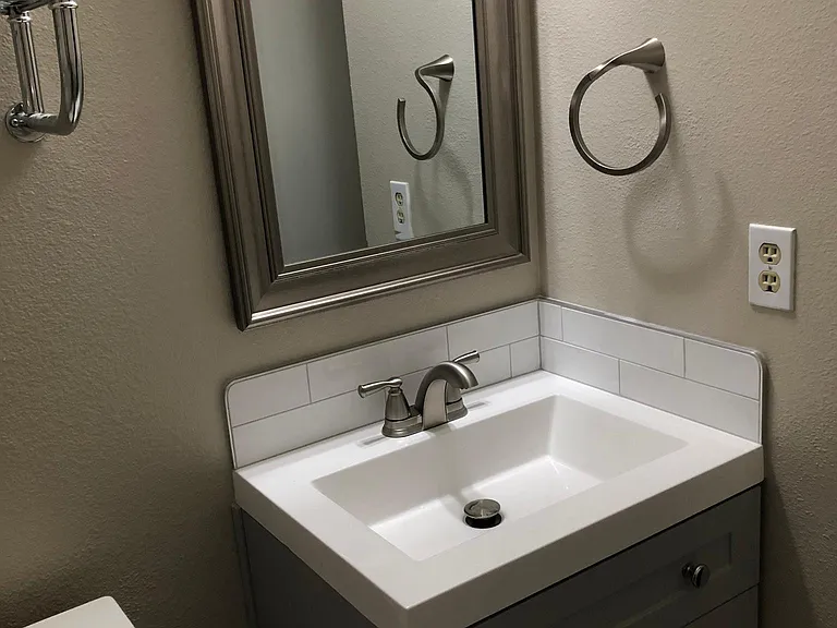 Remodeled 1/2 Bathroom with New Lavatory with Tile Back Splash and Tiled Floors (July 2022)