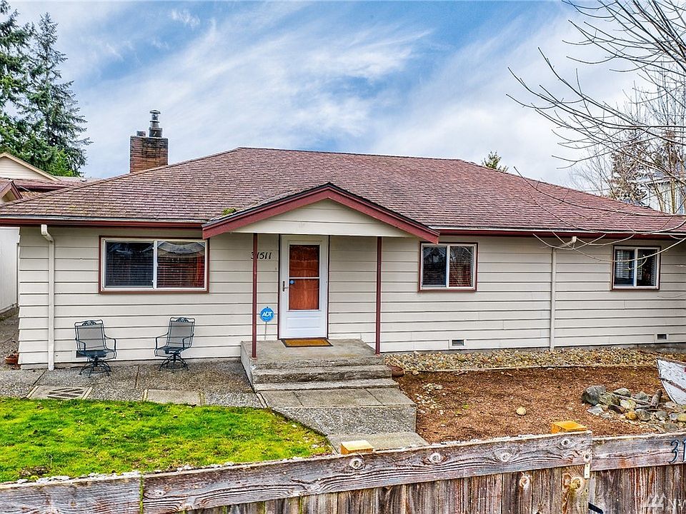 Cozy rambler tucked behind the fence, on it's 1/3 acre, along with outbuildings galore!