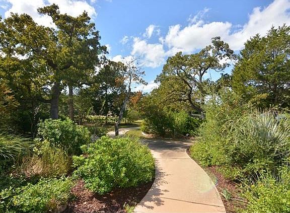 Lush landscaped front yard with sidewalk to extra off street parking!