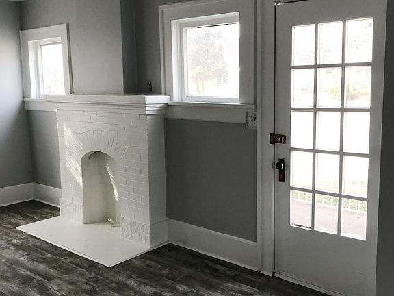 Living room featuring mock fireplace, lots of windows, new f