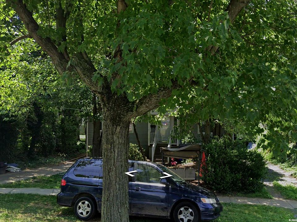 Front yard with 2 long, shaded driveways and a shared porch swing.