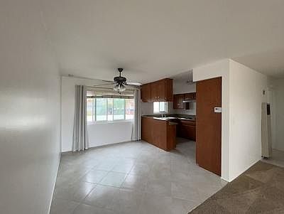 Kitchen with a breakfast bar. Lots of cupboards. Spacious dining area with easy care ceramic tiled flooring.
