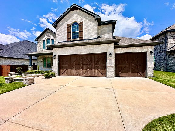 3-Car Garage | Ample Parking & Curb Appeal
Spacious 3-car garage with extended driveway -perfect for multiple vehicles, storage, or weekend projects. Attractive stonework & stained wood doors enhance the home's strong curb appeal.