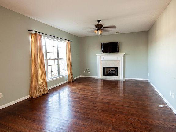 Large Den with Fireplace and Big Screen TV. Photo taken from Kitchen/Breakfast Area
