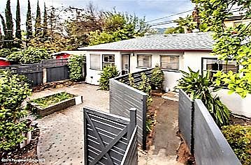 Privacy fencing separate the three units. Single family home