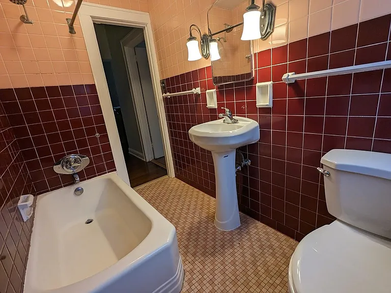 Original bathroom tile and cast iron tub. Sink, hardware for shower and toilet have been replaced in the past year. Lovely storage in the vanity and recessed drawers as seen in upcoming pic.