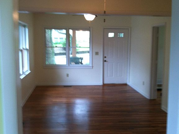 Same vantage point of the kitchen looking through the dining room towards the front door unfurnished.