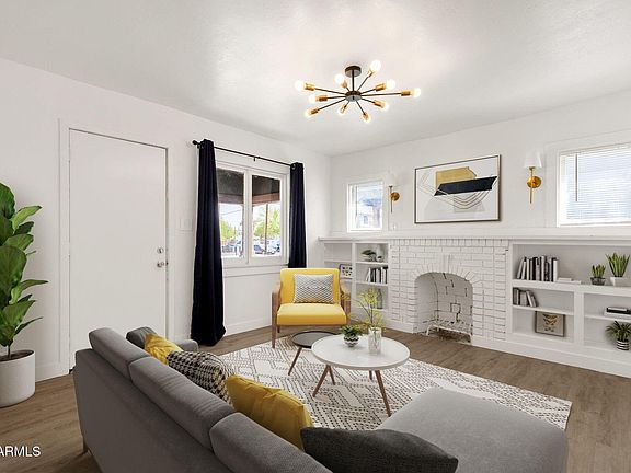 Bright, open living area with stylish LVP flooring and fireplace.