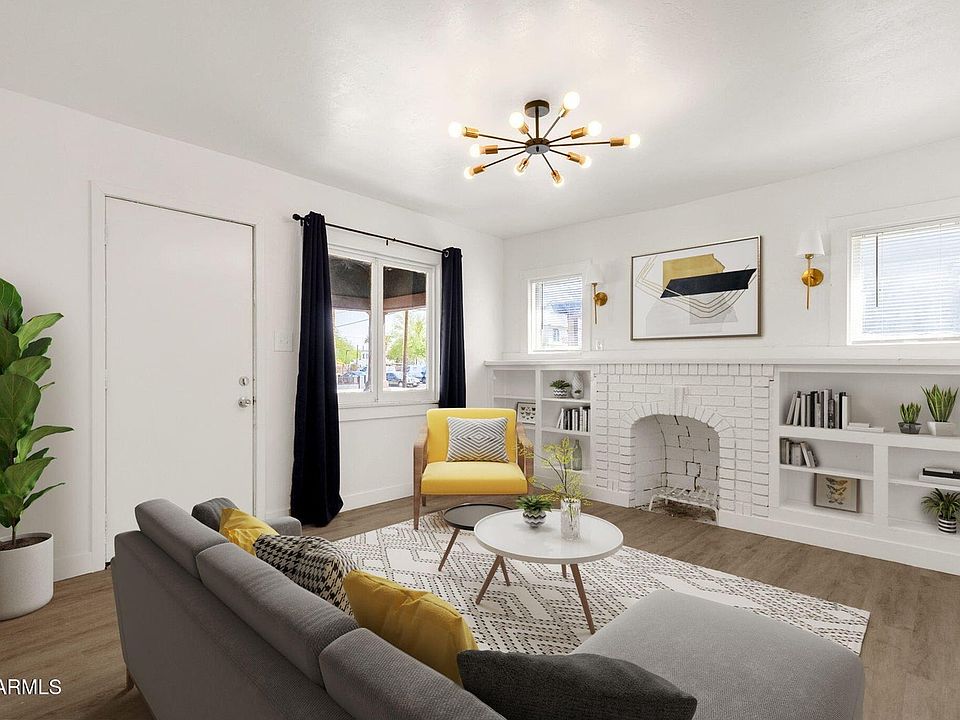 Bright, open living area with stylish LVP flooring and fireplace.