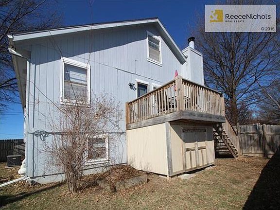 Side yard and storage below. Fenced backyard