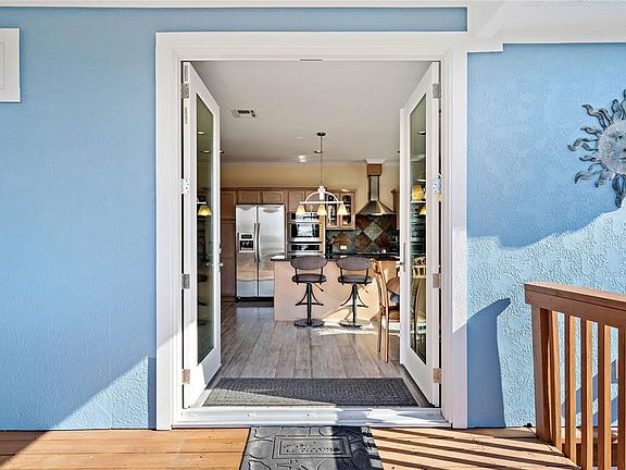 Enter this beautiful home through the canal-side decking to the open kitchen/dining concept.