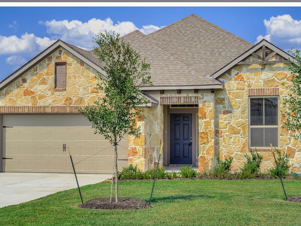 Rocky stone house with small patio entrance.