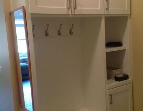 Off the garage entrance, you'll find this mudroom with built-in cubbies and ceramic tile floors.  The main floor laundry is located next to this and includes more storage and a utility sink.