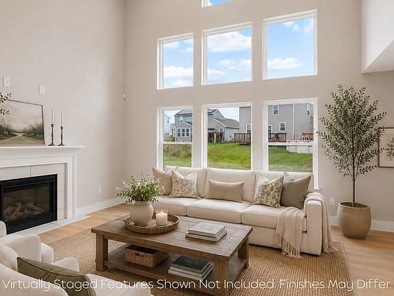 Light-filled living room with soaring ceilings and oversized windows