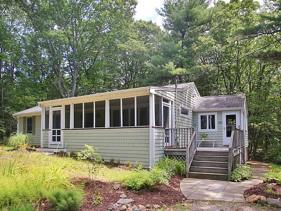 Front yard is mostly garden. Side walkway to back yard and additional storage.