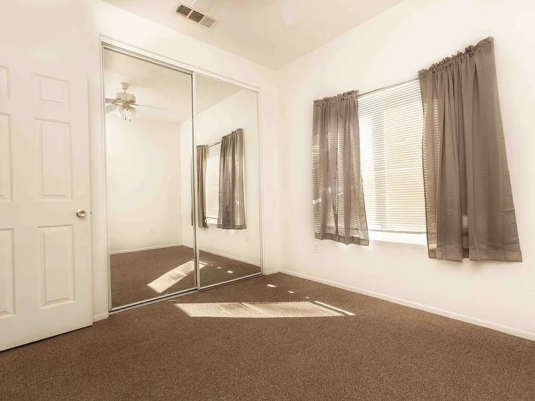 closet with mirror doors in bedroom #1