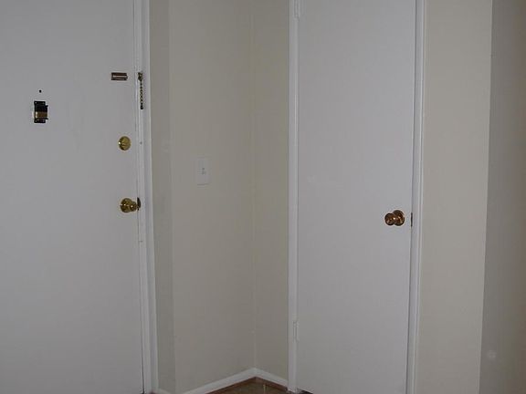 Ceramic tile entrance, coat closet on right