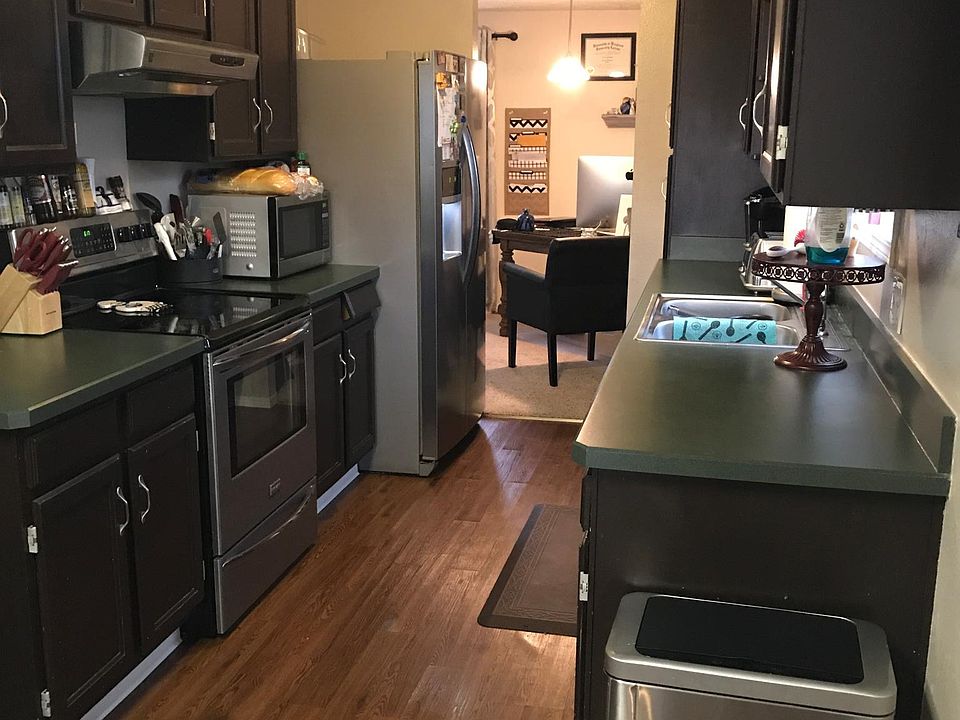 Galley kitchen w/older painted cabinets & newer stainless st