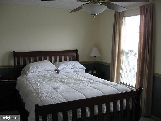 Master Bedroom w/laminate flooring and access to upper level bathroom from hallway & master bedroom