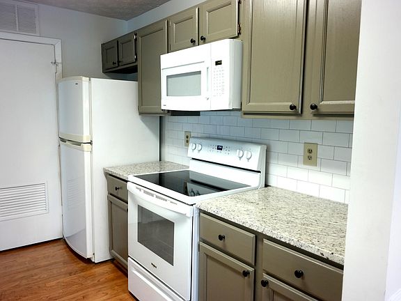 Kitchen with granite and subway tile backsplash.