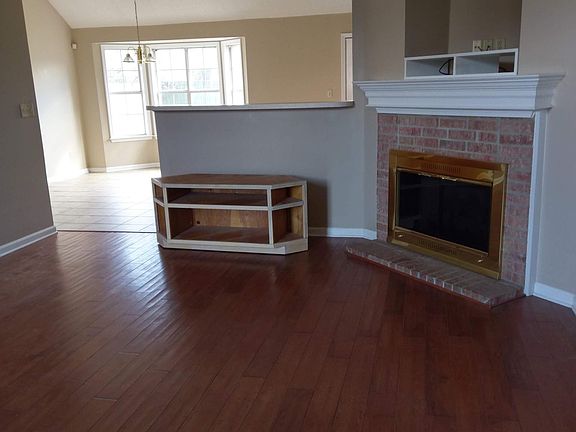 View from front door. Hardwood floors in living room; tile flooring in the kitchen and bathrooms.